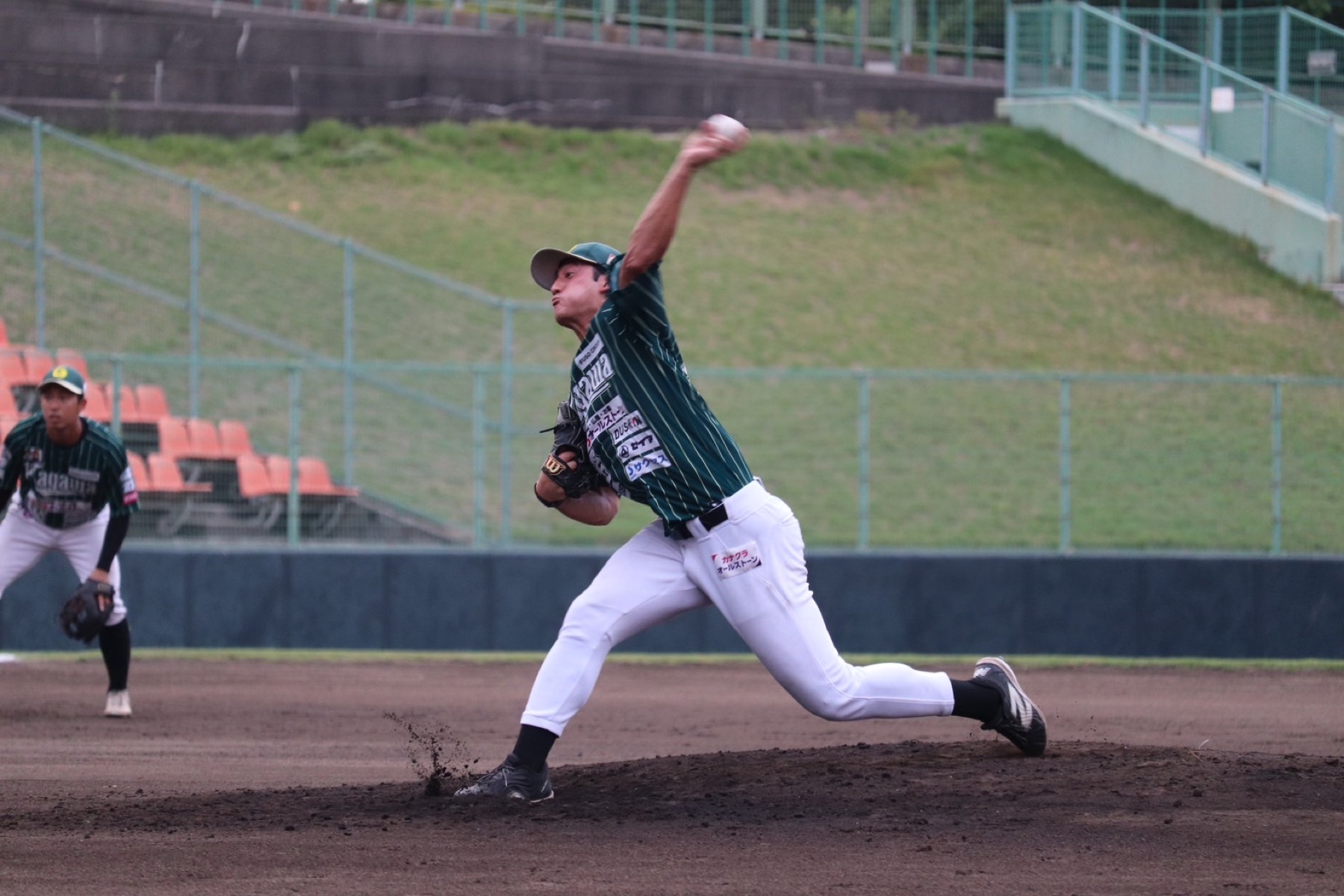 Kagawa Olive Guyners pitcher delivering a pitch